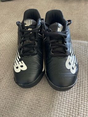 New Balance Kids Black Cleats with White Logo Accents